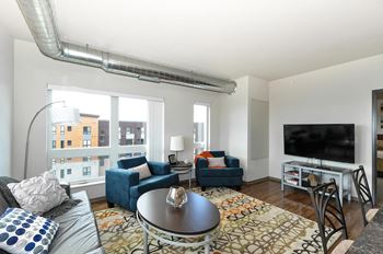 a living room with a couch and a tv at Bluestone Lofts, Minnesota